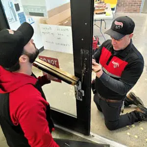 Access Control Technicians Install Motorized Latch Retraction Exit Device