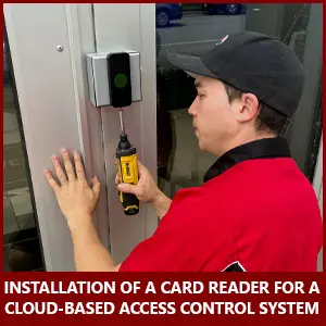 Access control systems technician installs a card reader for a cloud-based access system
