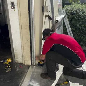 Locksmith installs continuous hinge during hollow metal frame installation in Greenville