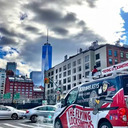 TFL service van driving to a commercial door repair near Manhattan in NYC