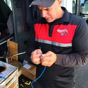 Security Technician Prepares Cat6 Cable for CCTV Camera Installation