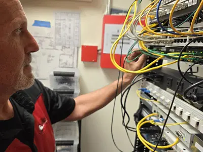NVR cable connections being made by a commercial security camera installer