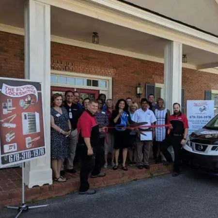The Flying Locksmiths team at a ribbon cutting ceremony where they completed a commercial security system installation near South Atlanta, GA
