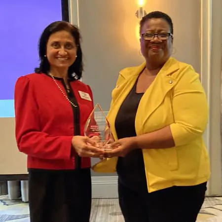 Latha Ravi is presented the SBA of Georgia women-owned business award