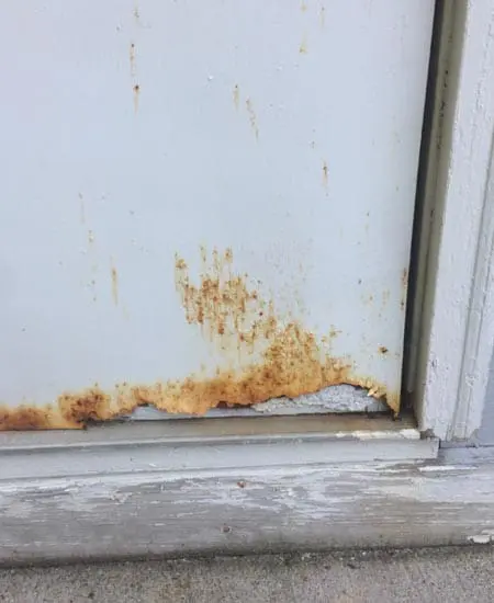 Image two of rust and light showing through an ugly door
