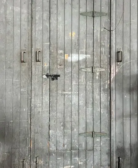 Image four of damaged hardware on an ugly door