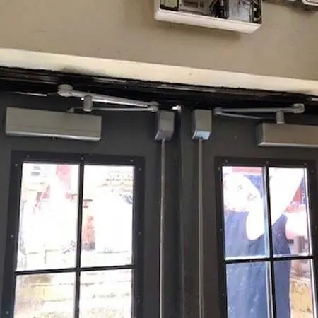 TFL technicians install door closers and electrified surface vertical rod exit devices for an access control system in Worcester, MA