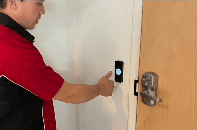 Technician installing a touchpad for an access control system.