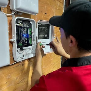 Security technician wires a door controller for an access control system