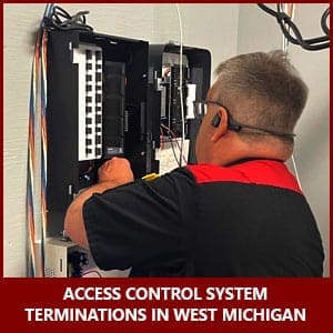 Security technician wires an access control panel in West Michigan