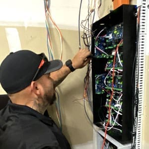 Access control specialist makes final terminations at an access control panel