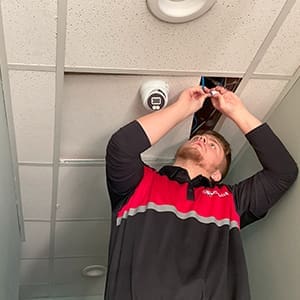 Kansas City Technician Connects Cat6 Cable For Security Camera Installation