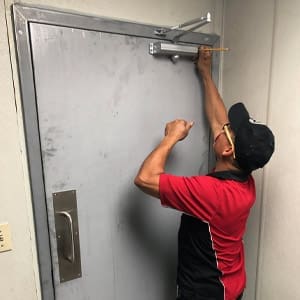 Door closer installation by a locksmith technician in San Diego