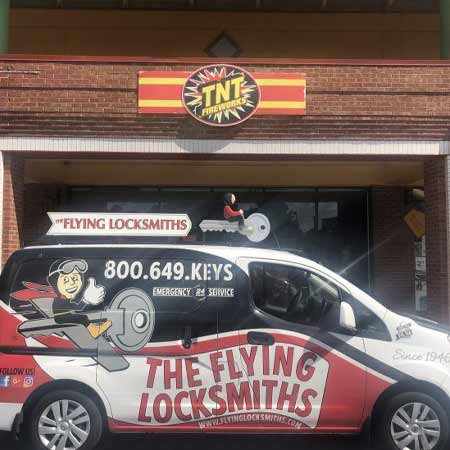 TFL technicians provide commercial locksmith services on storefront door at TNT store in Duluth, GA