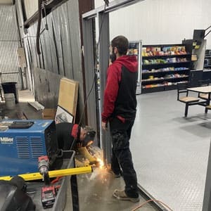 Locksmith is welding a hollow metal frame in Spartanburg, SC