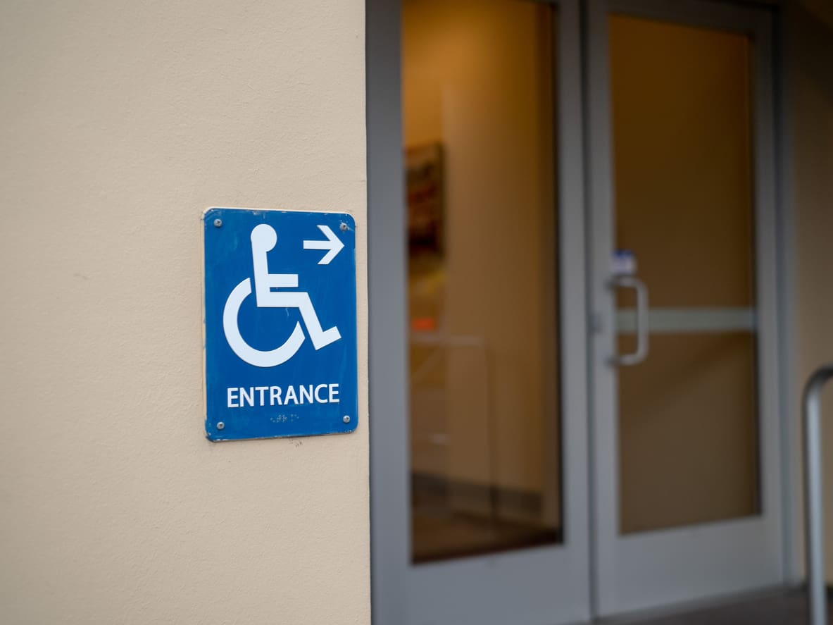 ADA Compliant door with wheelchair sign at door.